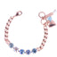 Rose gold bracelet with blue gemstones and heart charm on a white background