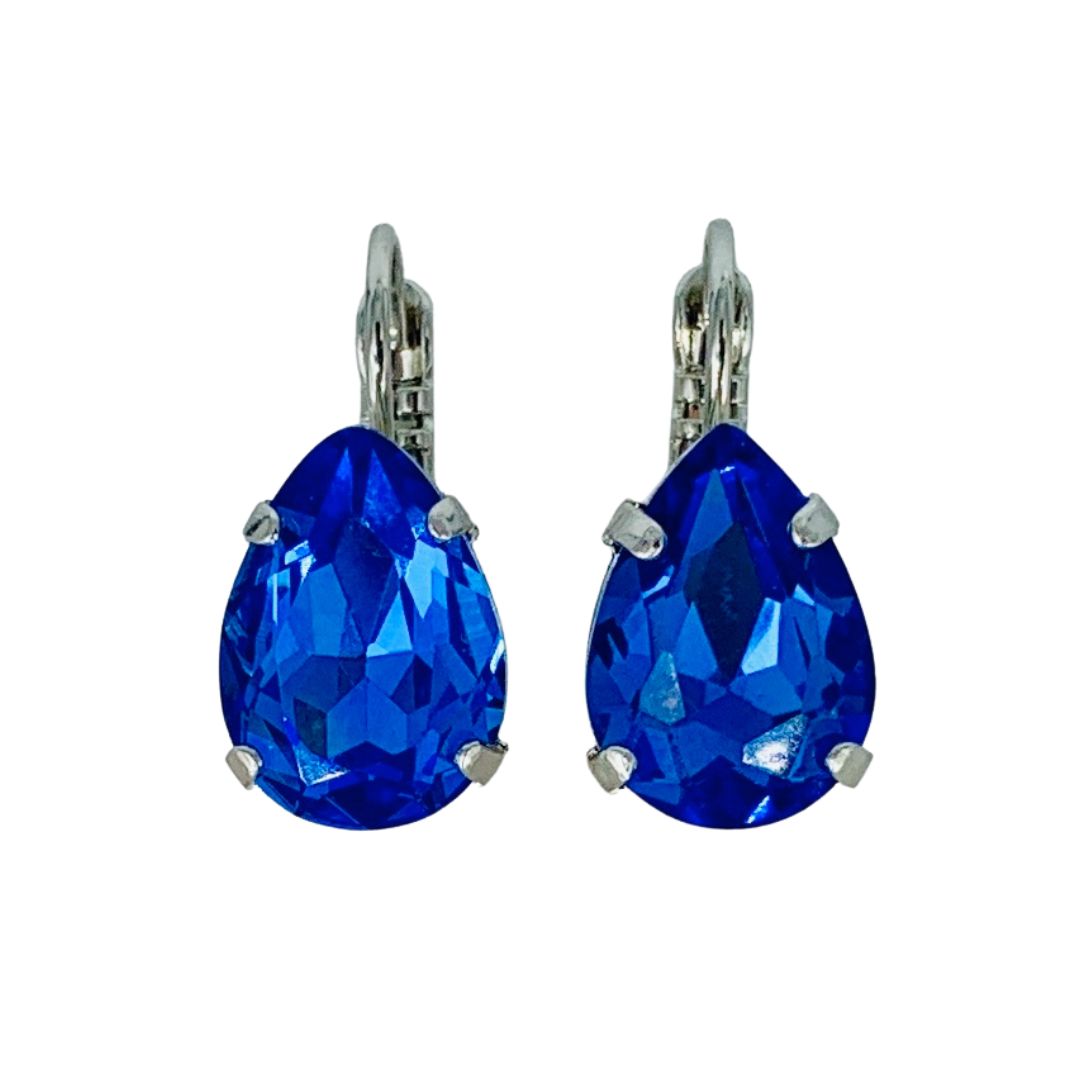 A pair of Mariana royal blue teardrop earrings with a rhodium finish.